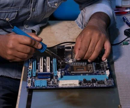 Technicians are using a soldering iron for repairing electronics 스톡 사진