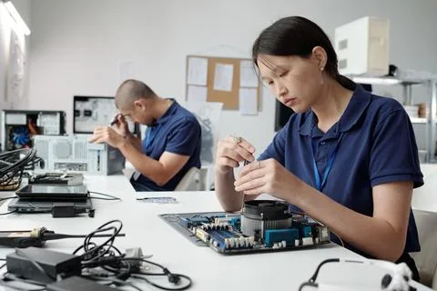 Technicians Assembling Computer Components in Laboratory 스톡 사진