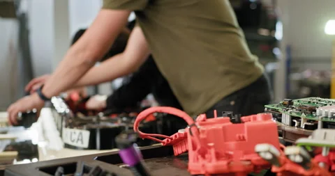 Technicians Assembling Electric Car Batteries in Workshop Stock Footage 277304216