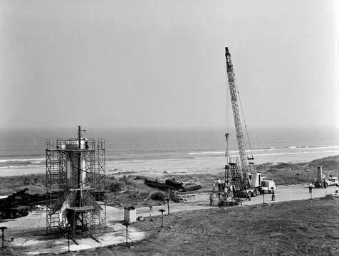 Technicians attach the escape tower to the Mercury capsule prior to assembl.. Stock Photos