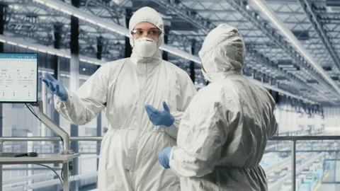 Technicians brainstorming in microchip smart factory to prevent downtime Stock Footage 333387793