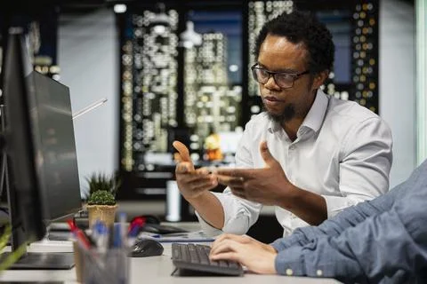 Technicians chatting in startup office, coding advanced machine learning models 스톡 사진