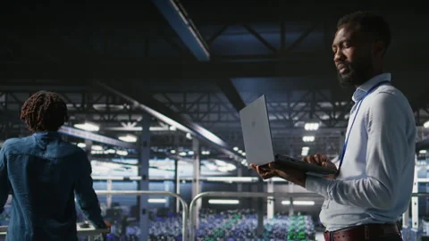 Technicians on data center industrial platform analyzing performance outputs Video stock 310784897