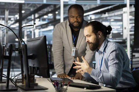 Technicians in data center office using computer, verifying firewall Foto stock