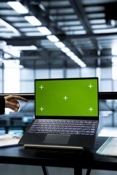 Technicians in data center using green screen mockup laptop, inspecting servers Foto stock