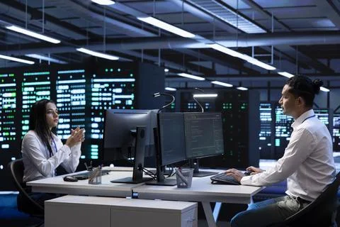 Technicians in data center workspace running system diagnostic tests Stock Photos