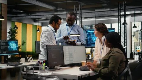 Technicians doing brainstorming in office, using AI specialized hardware Stockfoto's