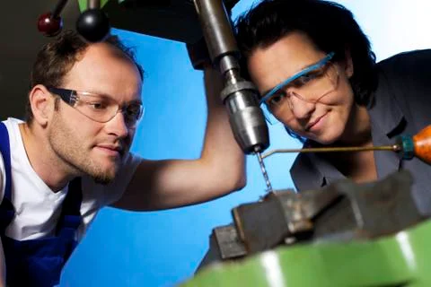 Technicians drilling in workshop Stock Photos