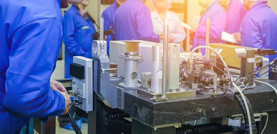 Technicians engage in hands-on training with specialized equipment in a conte Stock Photos