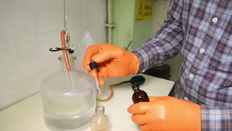 Technicians examining olive oil in factory Stock Footage 140219084