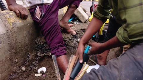 Technicians fix communication lines under the curbside Stock Footage 312382361