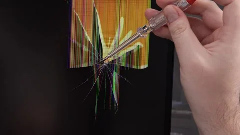 A technician's hand with a screwdriver diagnoses a cracked computer monitor.. Stock Footage 324964503