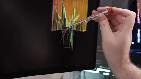 A technician's hand with a screwdriver inspects a shattered computer monito.. Stock Footage 324964442