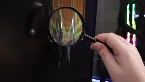 A technician's hand uses a magnifying glass to inspect a broken computer mo.. Stock Footage 324964453