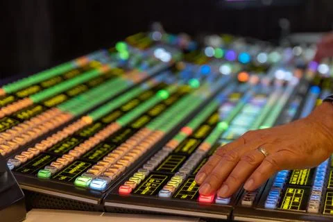 Technicians hands working on a video switcher Stock Photos