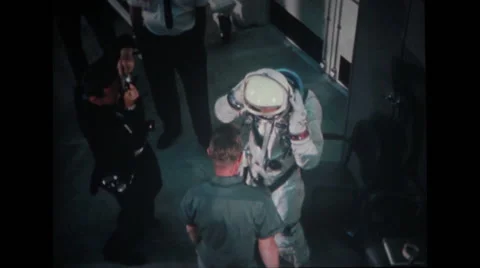 Technicians helping astronaut adjust his helmet Stock Footage 37596938