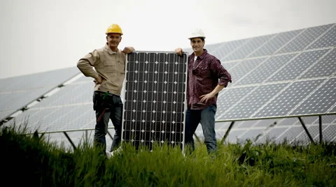 Technicians holding a solar panel Stock Footage 3739351