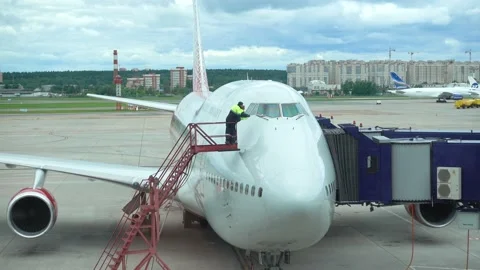 Technicians inspect the windshield of the aircraft. Stock Footage 131729231
