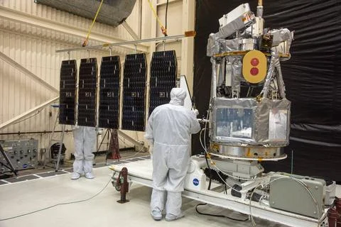 Technicians install the solar array for NASA s Ionospheric Connection Expl... Stock Photos