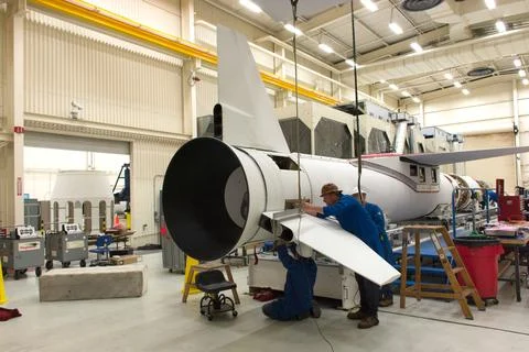 Technicians install the starboard fin on the Orbital ATK Pegasus XL rocket .. 스톡 사진