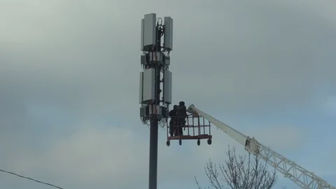 Technicians installing 5G equipment on cell phone tower Stock Footage 103243934