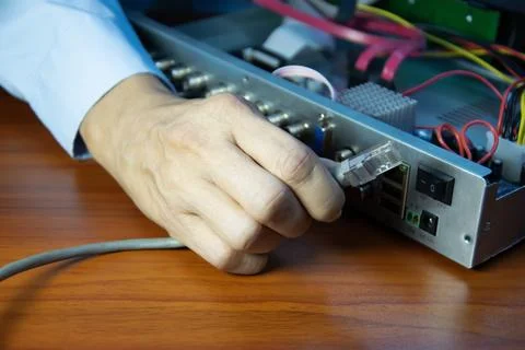 Technicians installing LAN cables at CCTV camera recorders Stock Photos
