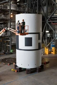 Technicians with Jacobs check the alignment during stacking of the aeroshe... Stock Photos