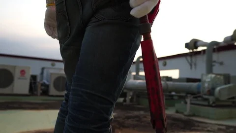 Technicians man holding a pipe wrench with warm light of sunset Stock Footage 105913054