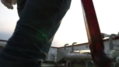 Technicians man holding a pipe wrench with warm light of sunset Video stock 105913332