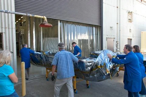 Technicians move the first half of the payload fairing for the Orbital ATK... 스톡 사진