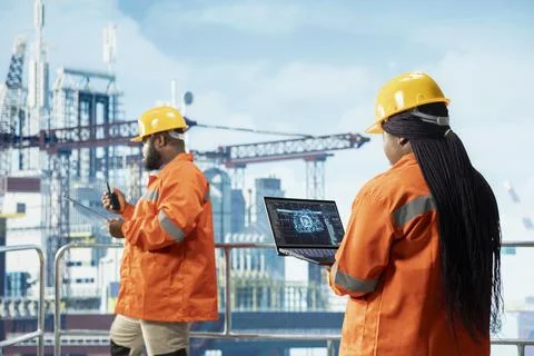 Technicians on offshore platform using artificial intelligence program on laptop Stock Photos
