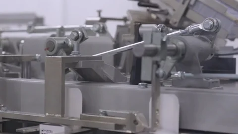 Technicians operate production machinery. Stock Footage 98406876