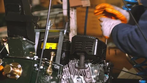 Technicians Performing Mechanical Assembly and Maintenance on Engine Unit Stock Footage 308043233