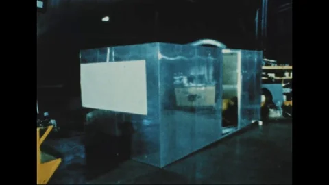 Technicians prepare aluminum booth for central section, insulate cellotape- 1968 Stock Footage 103593911
