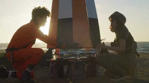 Technicians preparing the spaceshuttle model on the beach Stock Footage 108964132