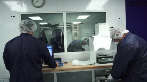 Technicians preparing to work in Cleanroom Stock Footage