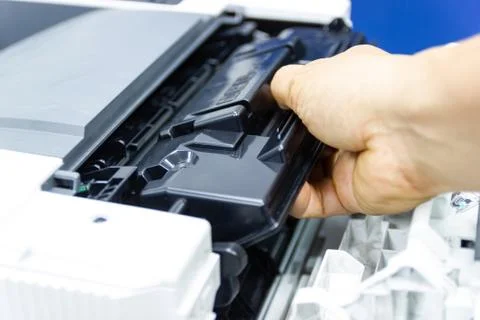 Technicians replacing toner in laser printer concept office supplies repair Photos