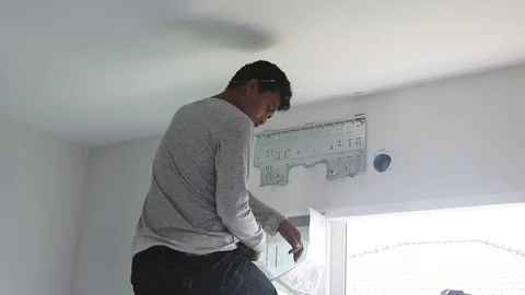Technicians screw the air conditioner base to the wall Video stock 98451292
