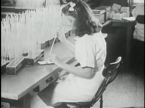 Technicians test blood samples of patient in laboratory - 1941 Stock Footage 97573609