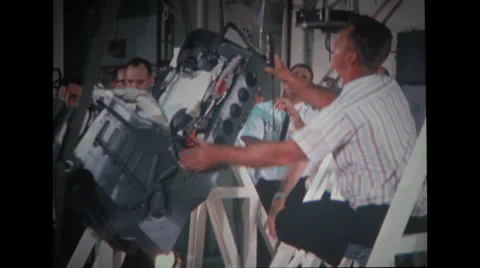 Technicians unstrapping spacecraft couch from stand Stock Footage 37597012