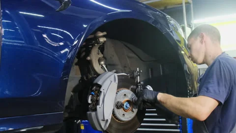 Technicians use special tool to secure wheel element Stock Footage 317650408
