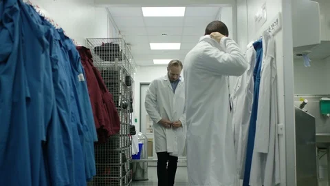 Technicians wearing laboratory coat in dressing room to visit production area Video stock 107963769
