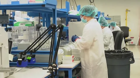 Technicians work at benches in a crime laboratory testing DNA samples Video stock 345299200