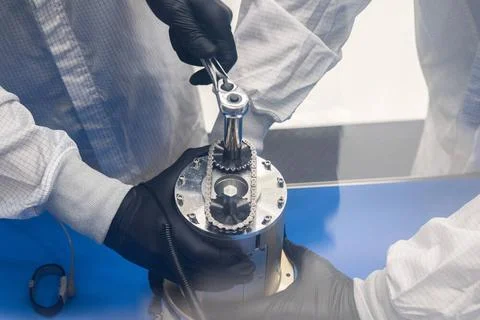 Technicians work on installing ejectable data recorders onto NASAs Low-Ea.. Stock Photos