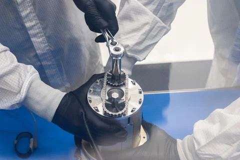 Technicians work on installing ejectable data recorders onto NASAs Low-Eart.. Stock Photos