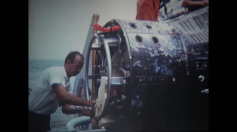 Technicians  working and examining spacecraft on USS Wasp Stock Footage 37596827