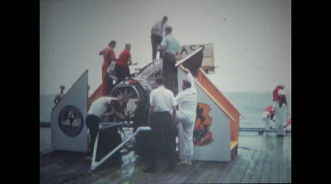 Technicians working and examining the spacecraft on deck Stock Footage