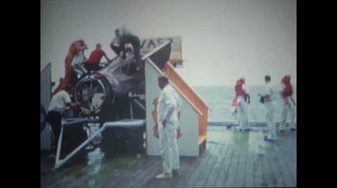 Technicians working and examining the spacecraft on deck Stock Footage