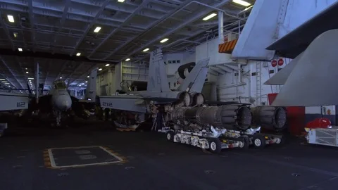 Technicians working on fighter aircrafts inside the USS Carl Vinson Stock Footage 117711727