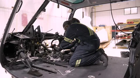 Technicians working on helicopter interior Video stock 221032260